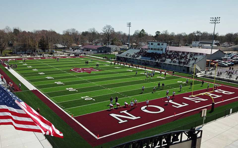 Aerial view of burgundy and green football field