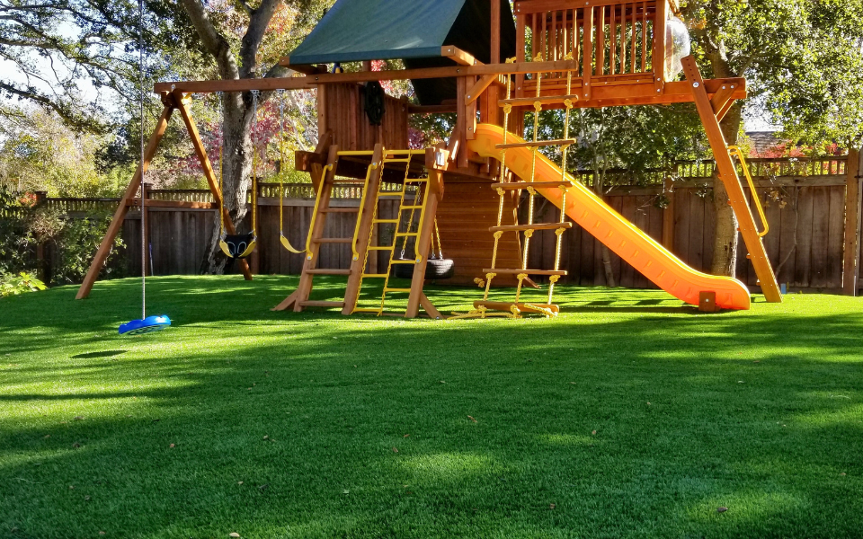 Wooden Playset in Backyard on Turf