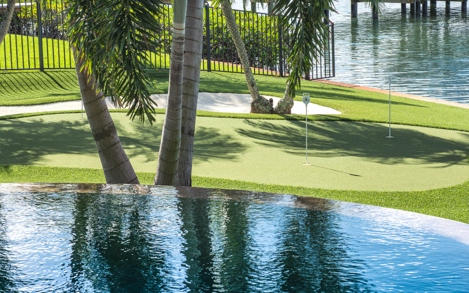 Putting green beside pool and lake