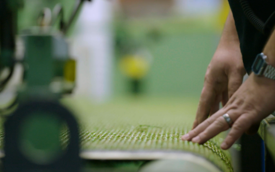 Inspecting turf backing on manufacturing machine